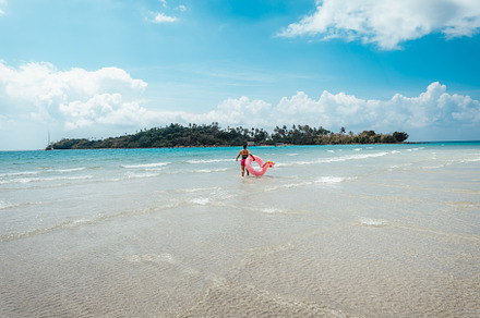 Travel to the sea and islands Woman walking into the clear sea o, a Holiday Photo by Art Rachen