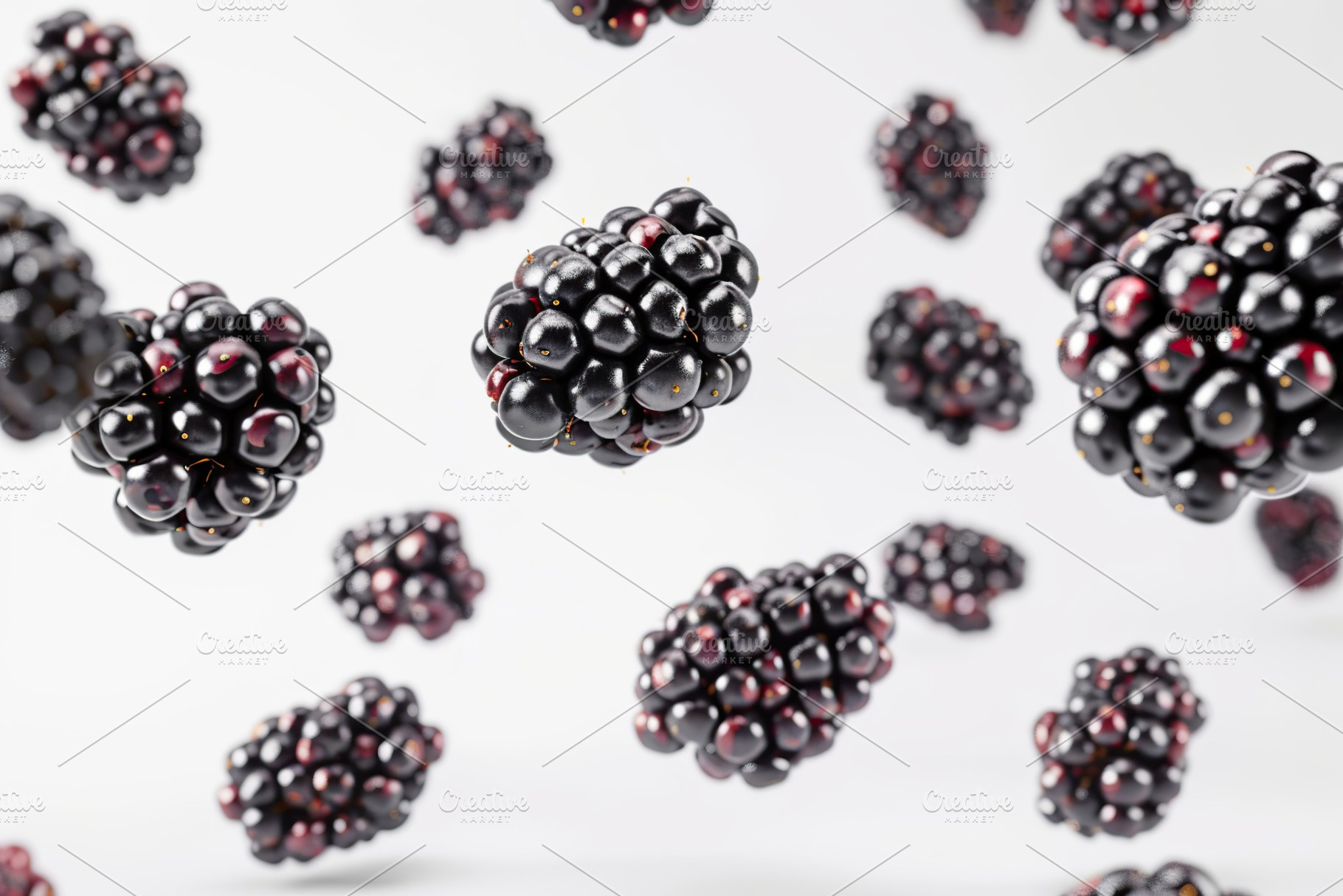 Ripe blackberries flying in the air on white background, a Food & Drink Photo by AlyaAnd