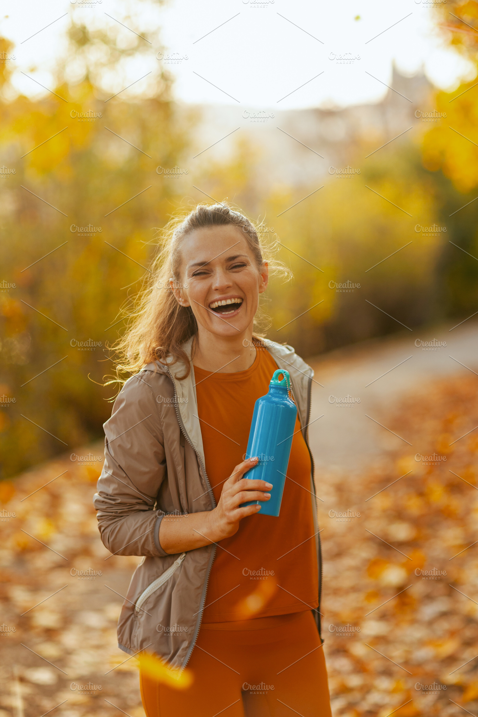 smiling fit 40 years old woman in fitness clothes in park, a Person Photo by Alliance Images