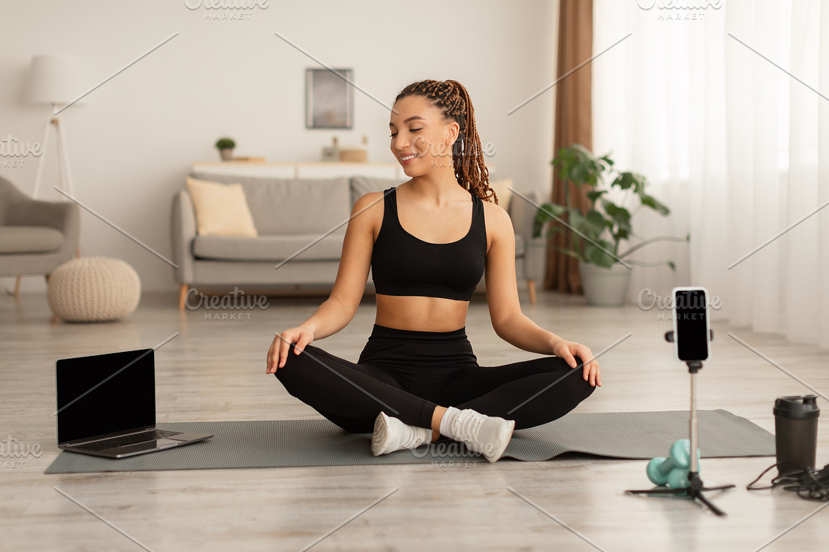 African Blogger Lady Sitting In Lotus Position Making Video Indoor, a Photo by Prostock-Studio (Photo 1 of 2)