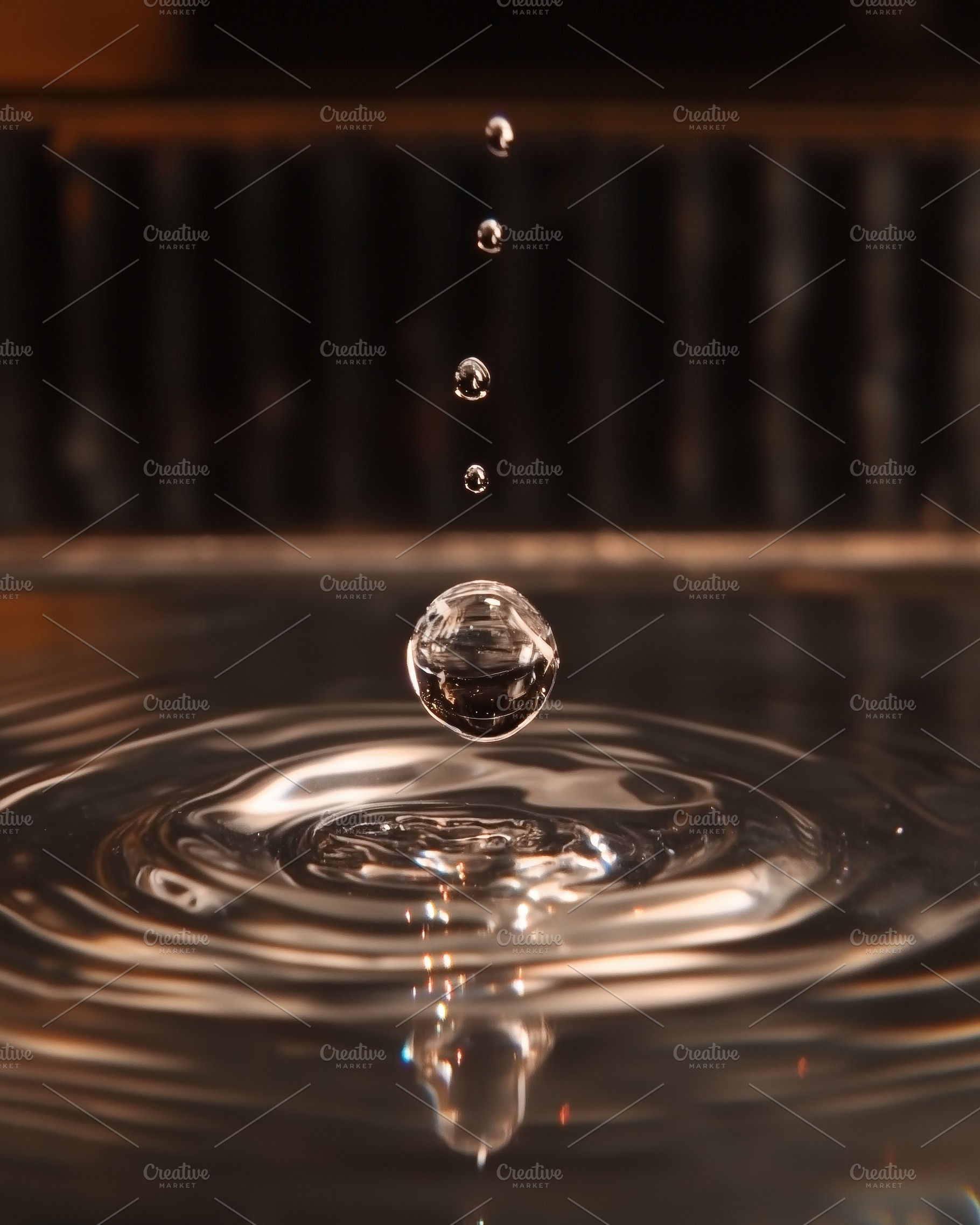 A close-up shot of a water droplet falling into a pool of water, creating rippl, a Photo by Textures & Backgrounds