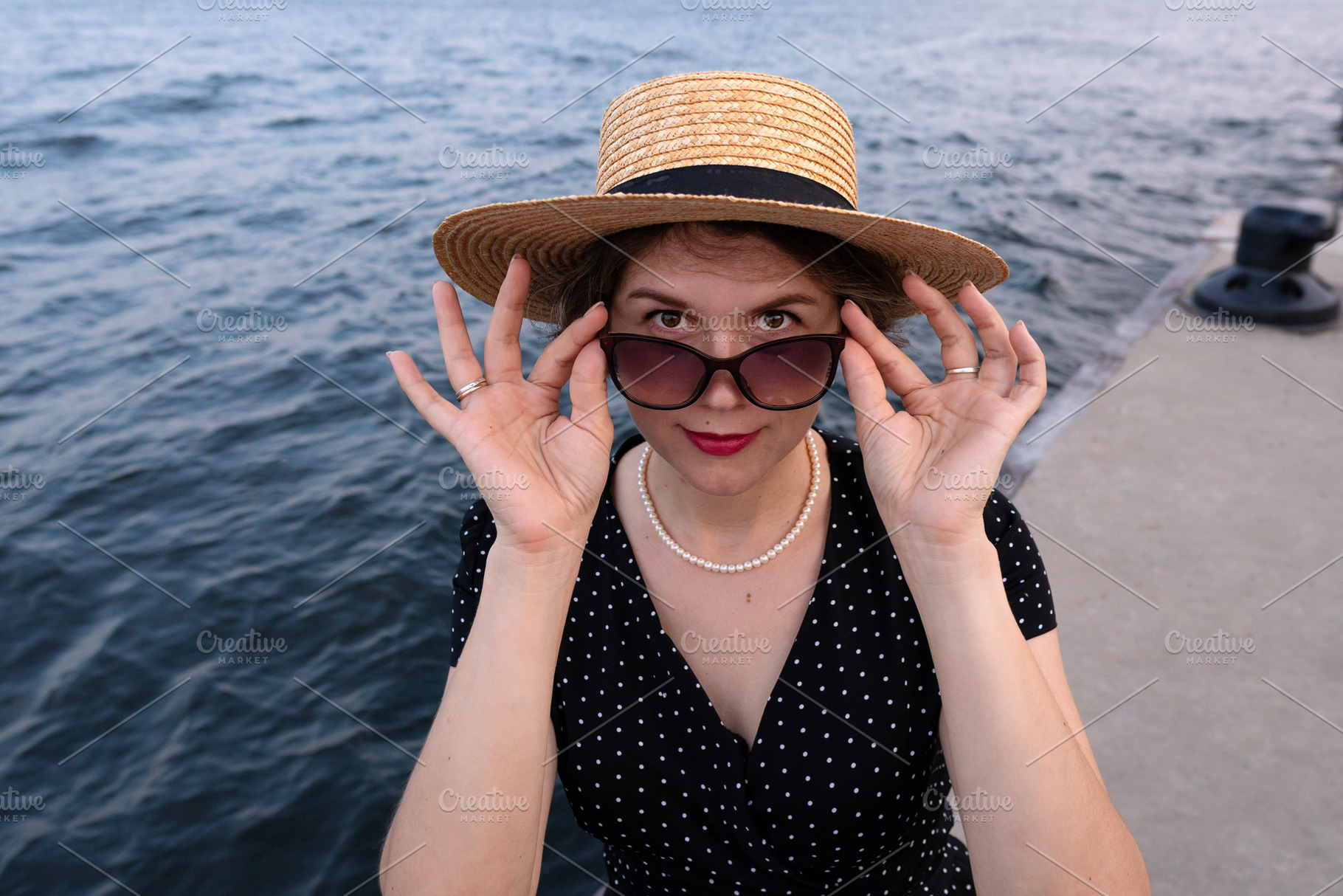 Portrait of woman adjusting sunglass, a Person Photo by Elena Vagengeim