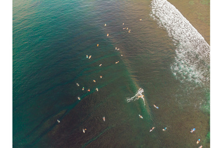 Surfers on the waves in the ocean, a Nature Photo by Elizaveta Galitskaya