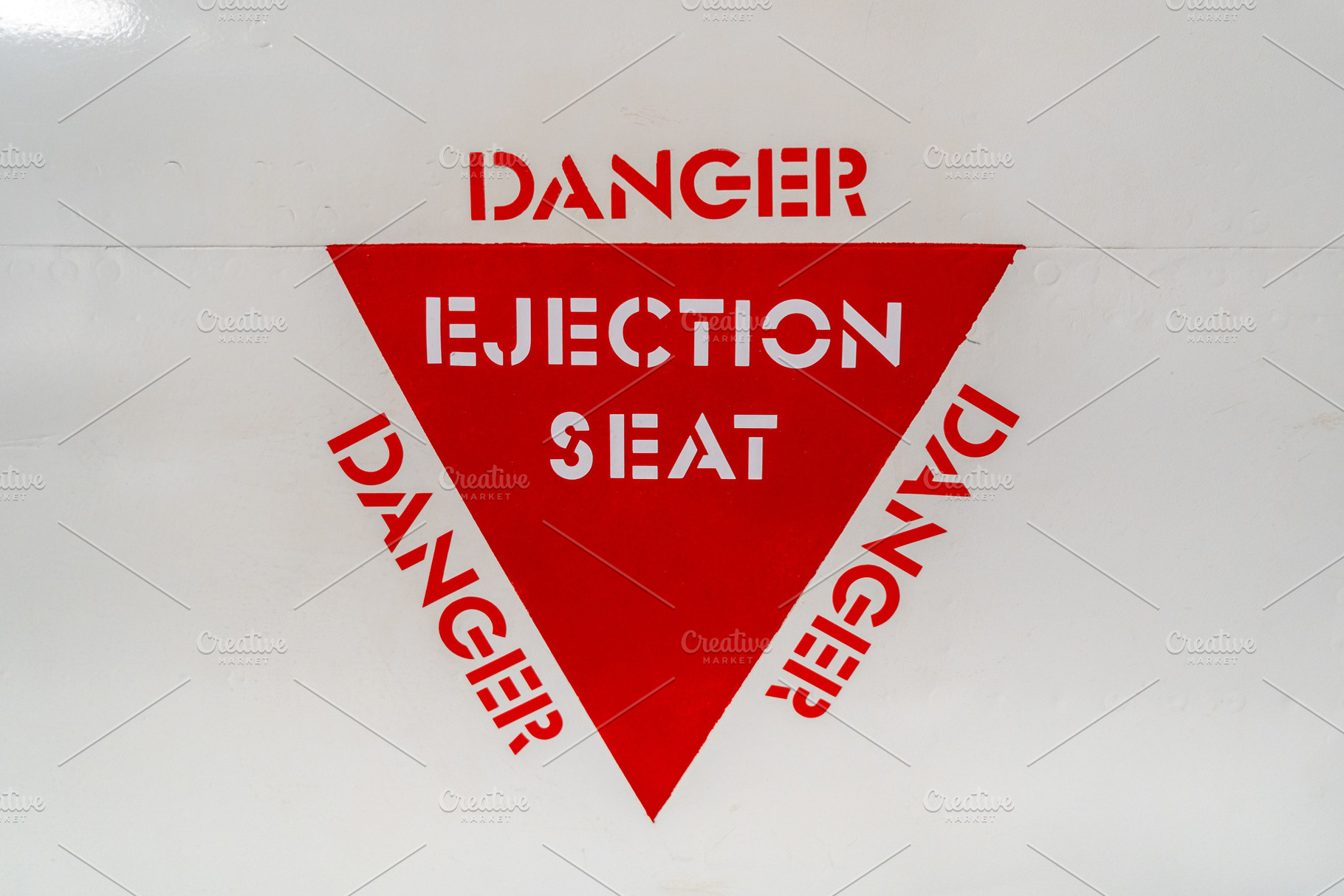 Ejection seat warning sign on an old aircraft fuselage close-up, a Background Photo by GoodGoods