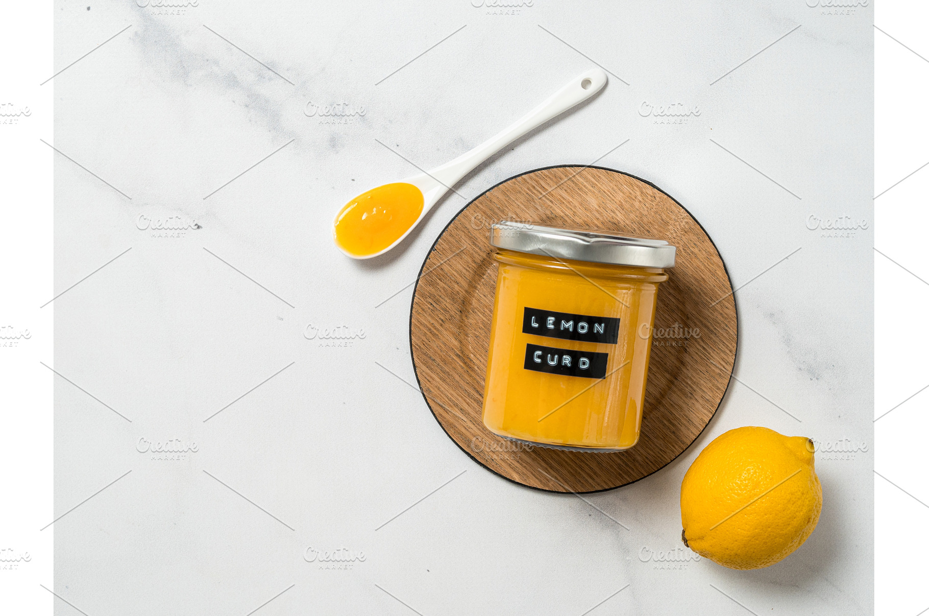 Homemade lemon curd in jar, top view, a Food & Drink Photo by Fascinadora