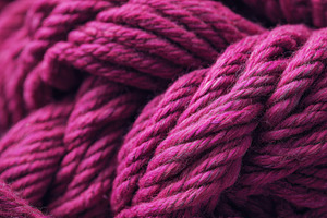 Vibrant pink yarn strands interwoven, a Photo by Beautiful things