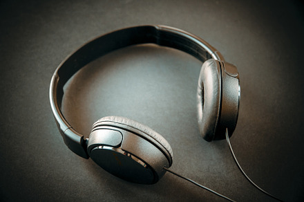 Headphones on a black background, a Technology Photo by GoodGoods