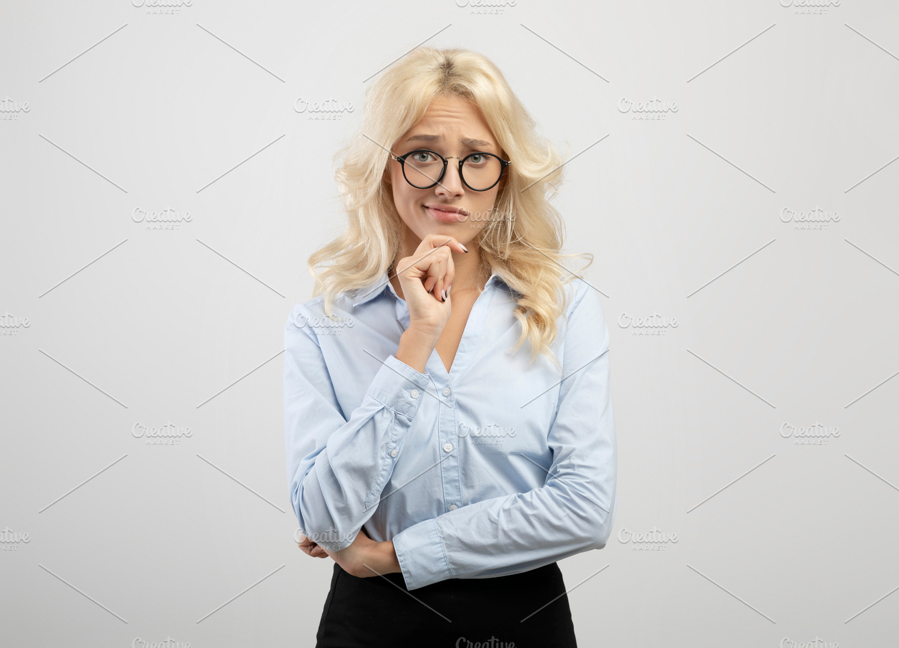 Making decision. Portrait of pensive businesswoman in glasses looking at camera, a Photo by Prostock-Studio