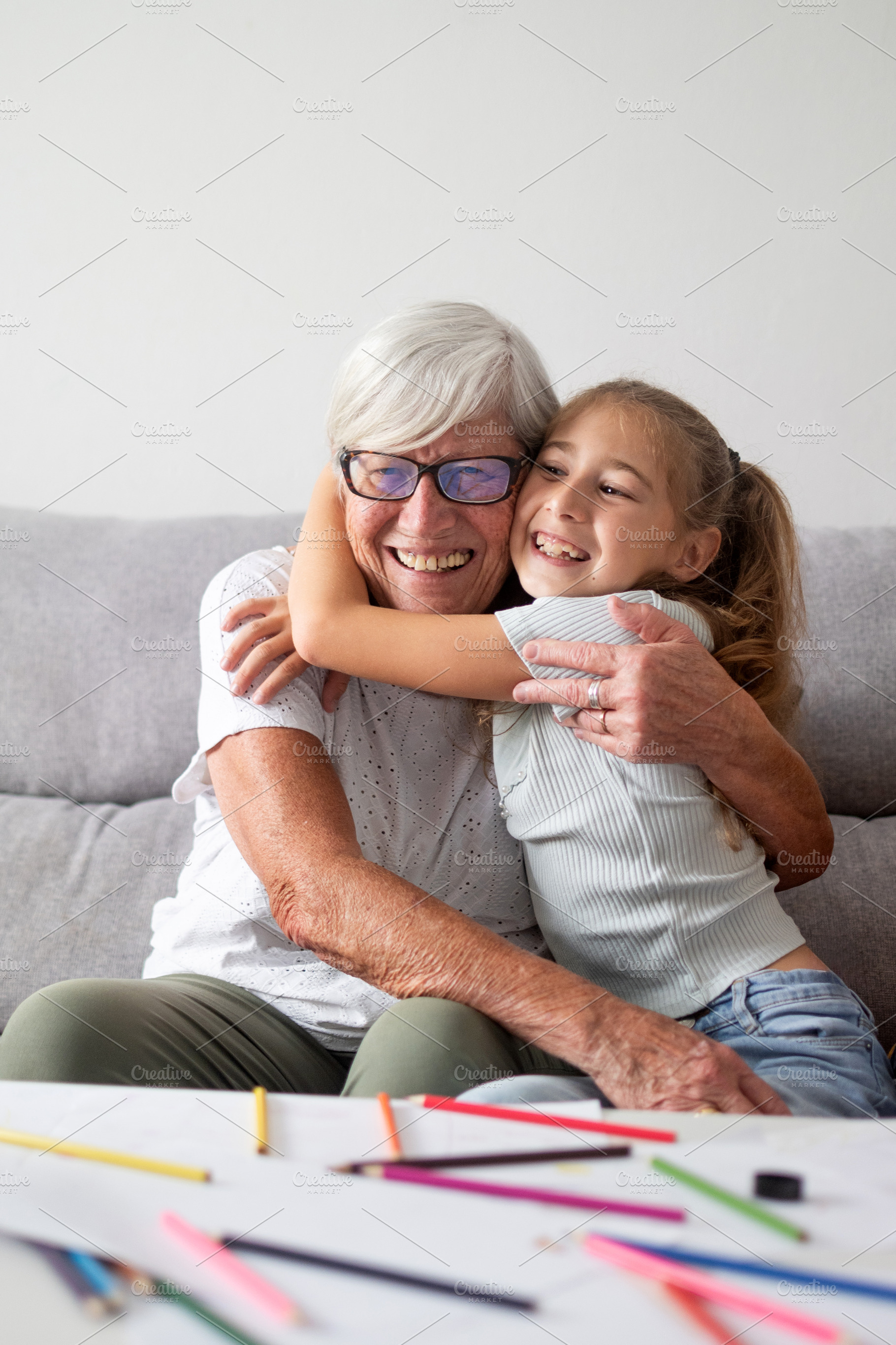 Happy grandmother hugging her granddaughter at home, a Person Photo by etorres69
