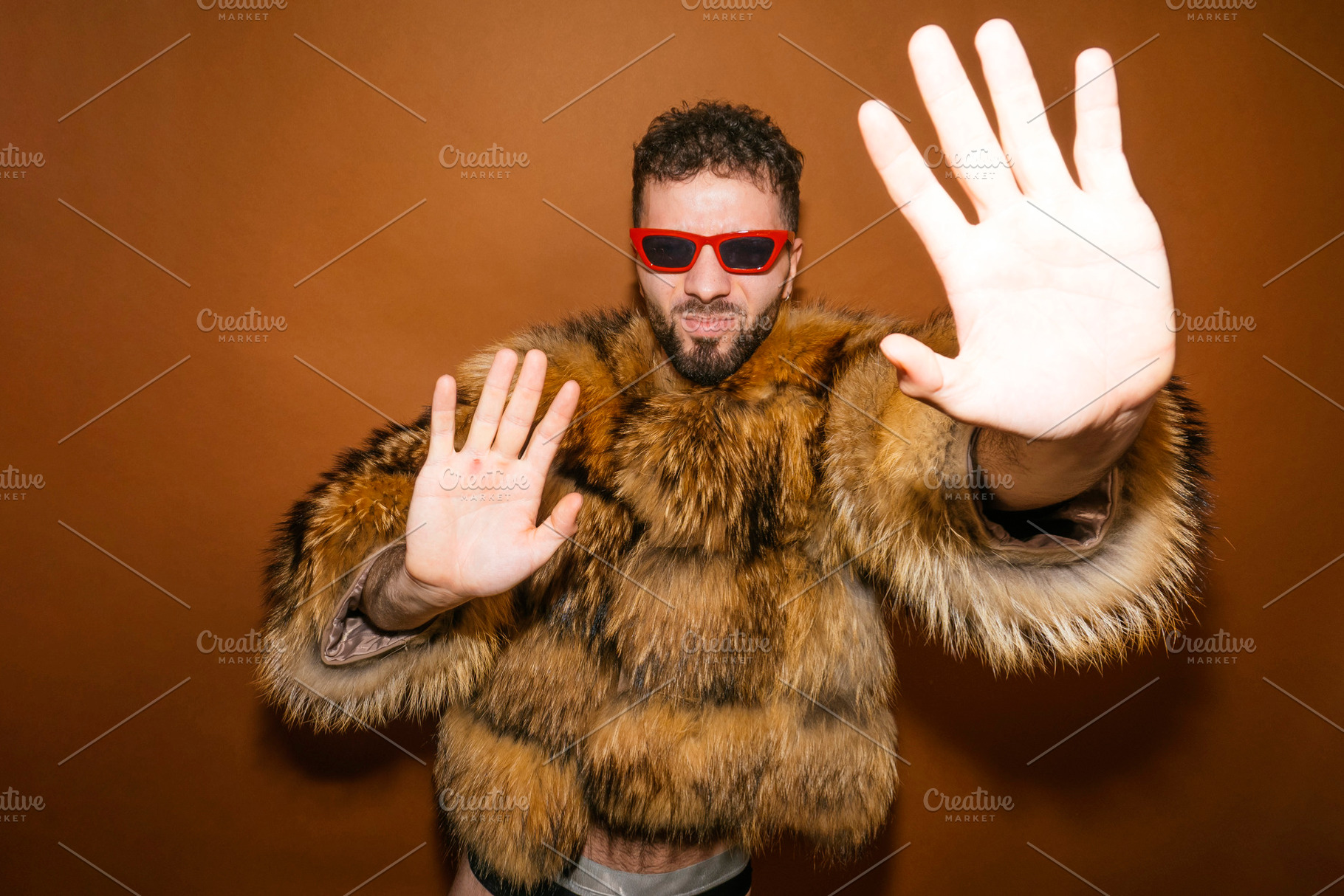 Queer man refusing attention with stop gesture, a Photo by karrastock