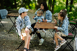 Family Enjoying Outdoor Time Together at a Cafe During Sunny Day in Park, a Person Photo by AS photostudio