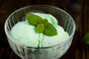 icecream with mint smell, natural ice cream with mint flavor, green mint sprigs, a Photo by rsoollAI