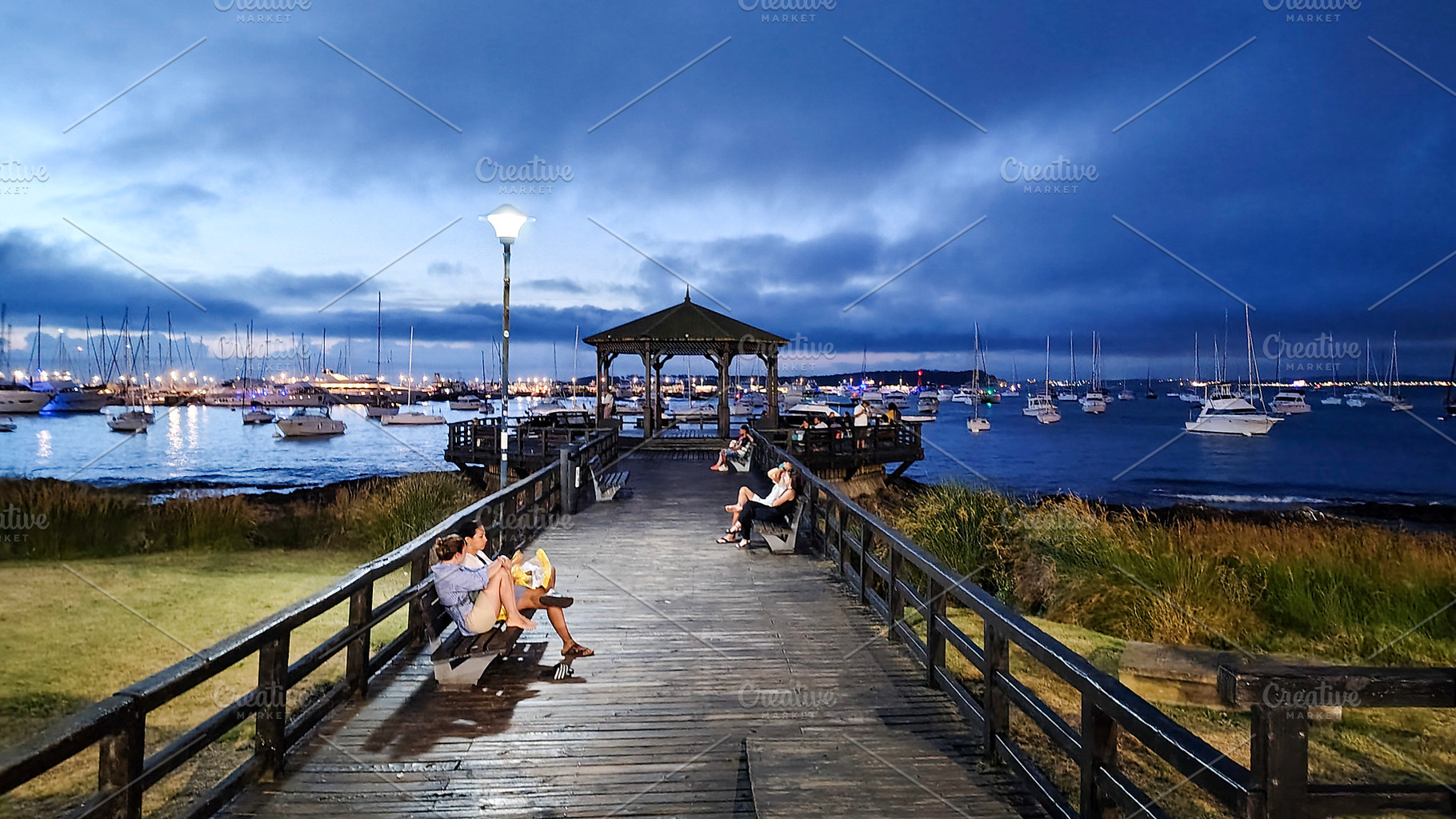 Wooden boardwalk and ships at background, punta del este city, u, a Person Photo by DanFLCreativo
