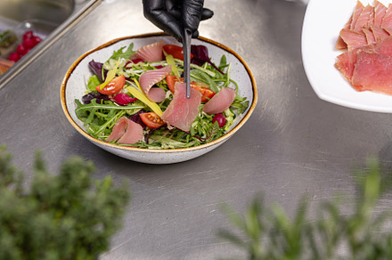 Chef preparing tuna salad, a Photo by Grafvision photography