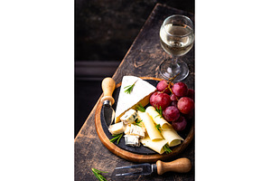 Different types of cheese, wine and, a Food & Drink Photo by Yulia Furman