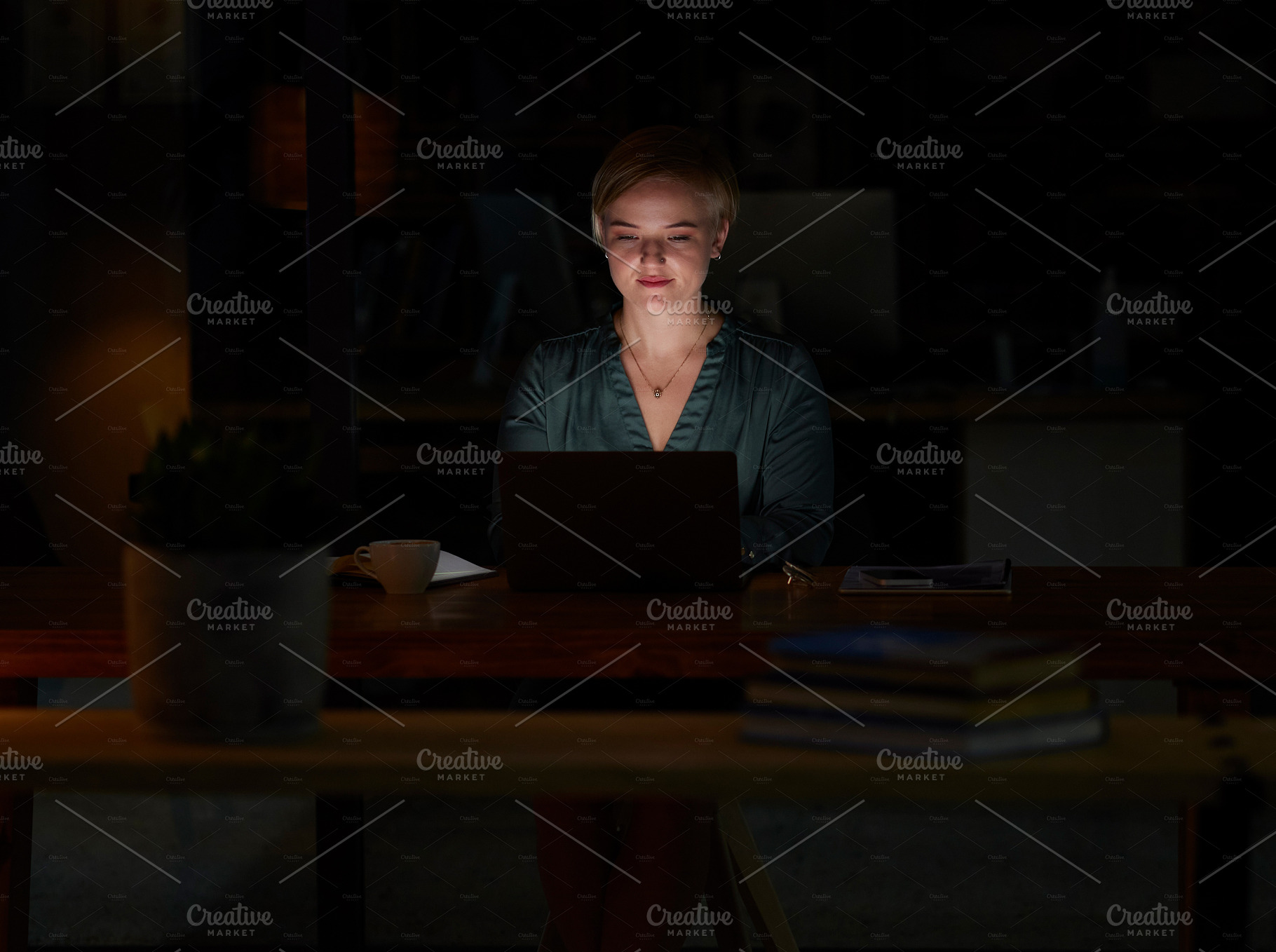 Night, laptop and concentrating with woman in office for planning, overtime or corporate mockup. Strategy, technology and email with employee typing proposal at desk for proposal, trading or internet, a Photo by Peopleimages.com