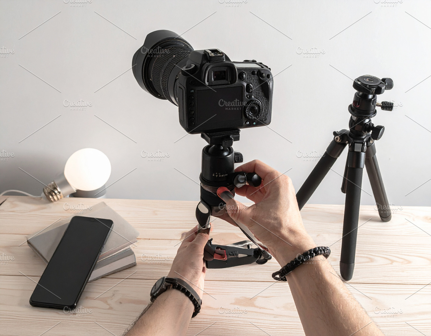 Wooden desk with hand handling with filming equipement, a Technology Photo by DanFLCreativo
