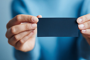 A person holding a blank dark card, a Business Photo by MistyDay