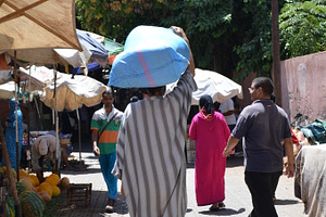 Man carrying a bag on arabian market