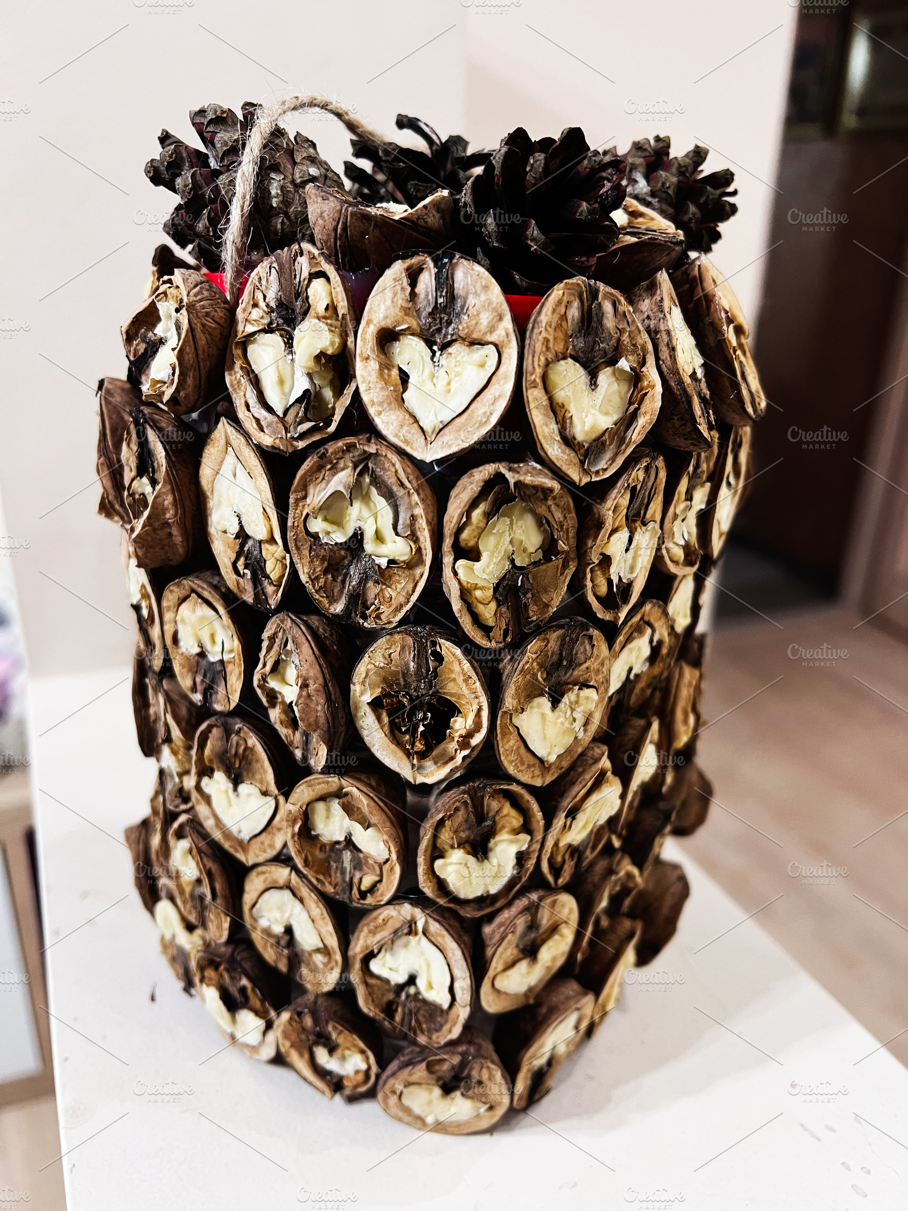 Rustic walnut shell centerpiece made from dried shells with heart shapes and pi, a Photo by AS photostudio