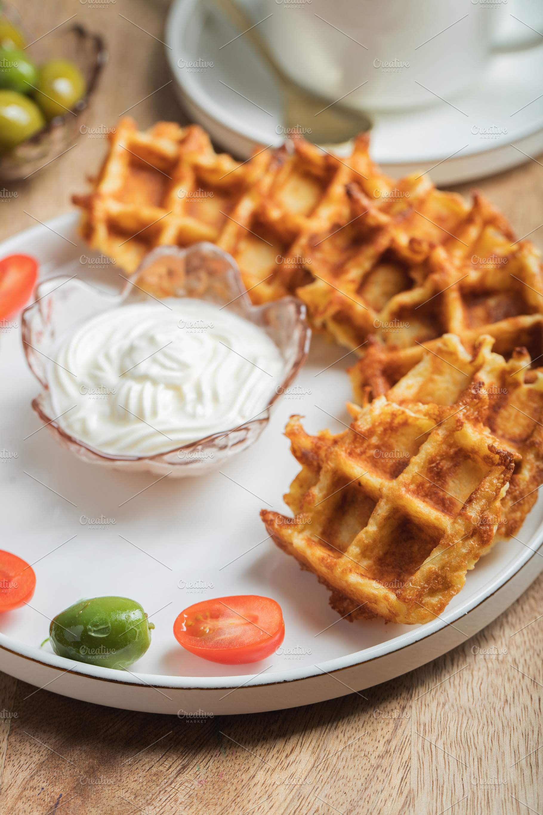Top view of Homemade Potato Waffles, ricotta cheese and mayonese sauce. Served, a Food & Drink Photo by Budarinphoto