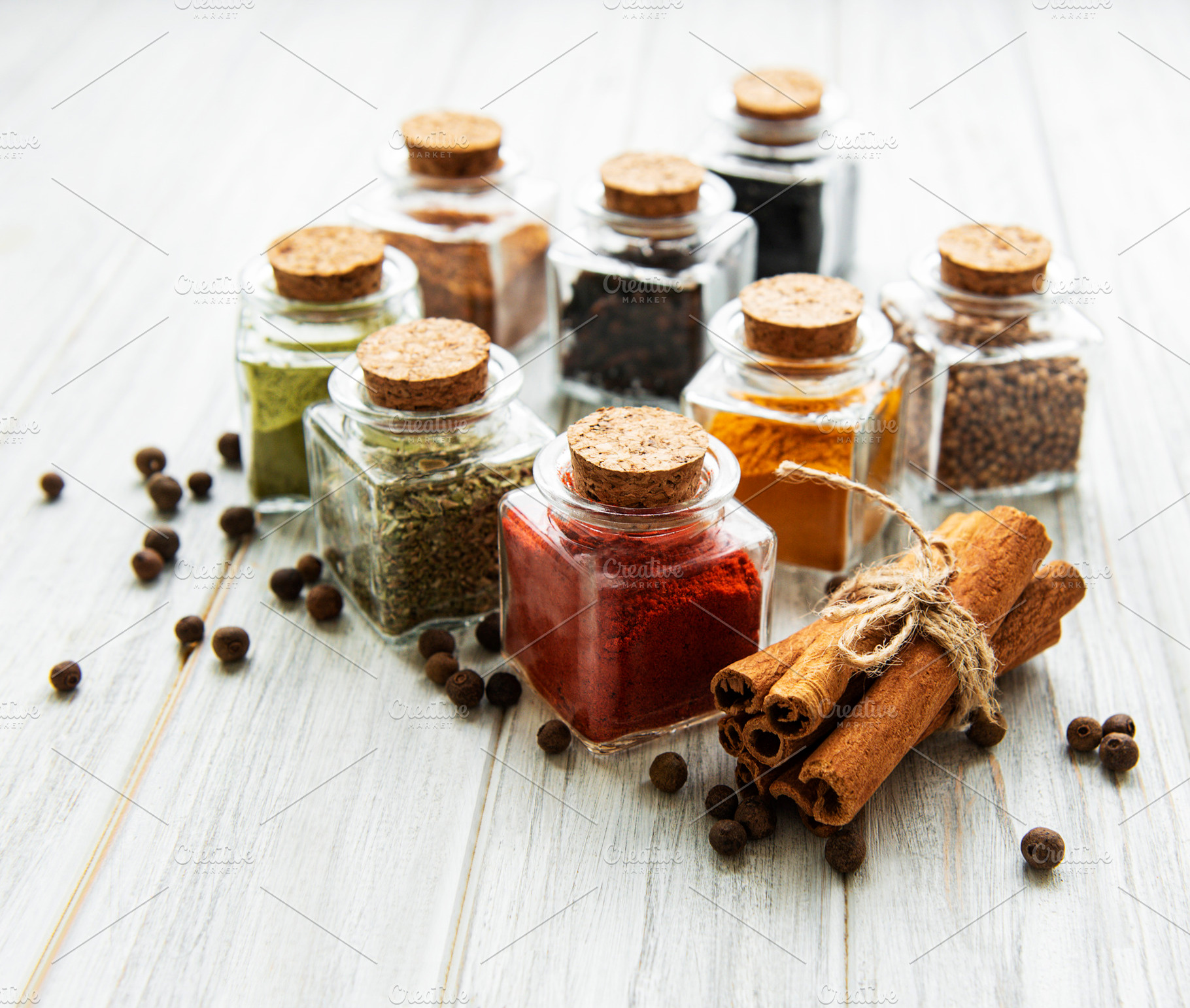 Jars with dried herbs, spices on the table, a Food & Drink Photo by Olena Rudo
