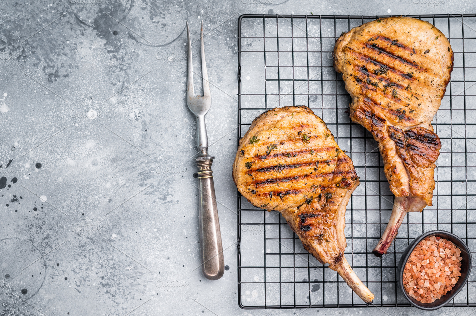 Juicy grilled pork Tomahawk chop, perfectly seared and bursting, a Food & Drink Photo by composter-box@mail.ru