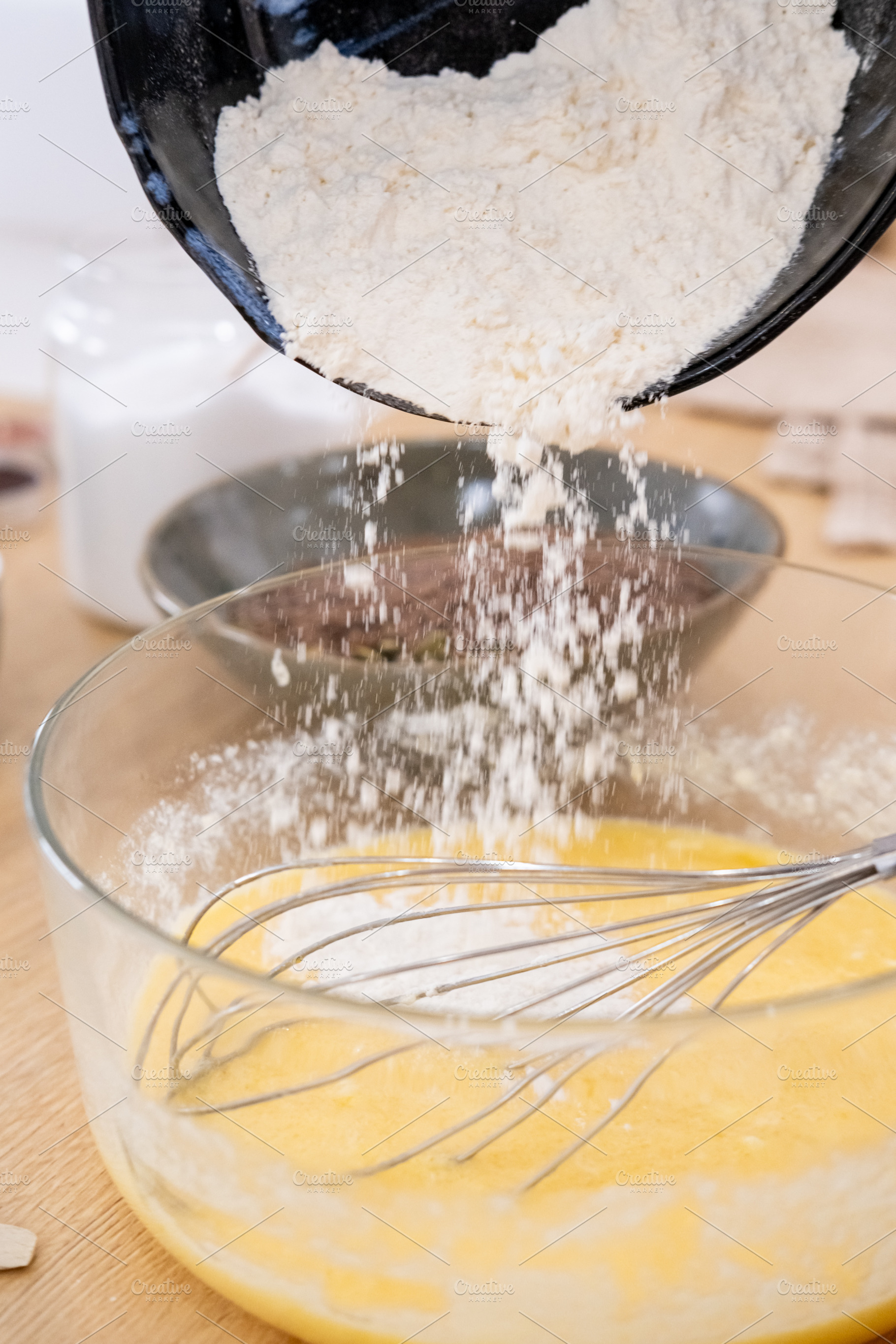 Dough making pouring flour batter whisk bowl table, a Food & Drink Photo by Photo Drive Studio