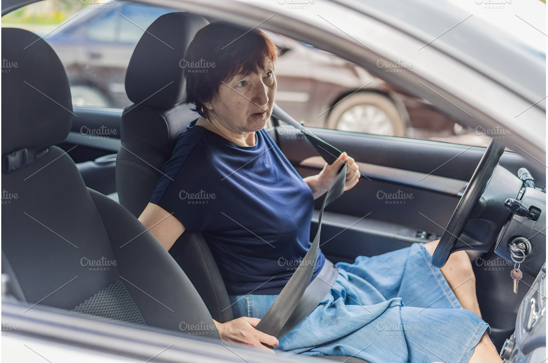 Older woman driving a car with focus, a Transportation Photo by Elizaveta Galitskaya