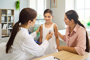 Pediatrician Examining Girl with Mom
