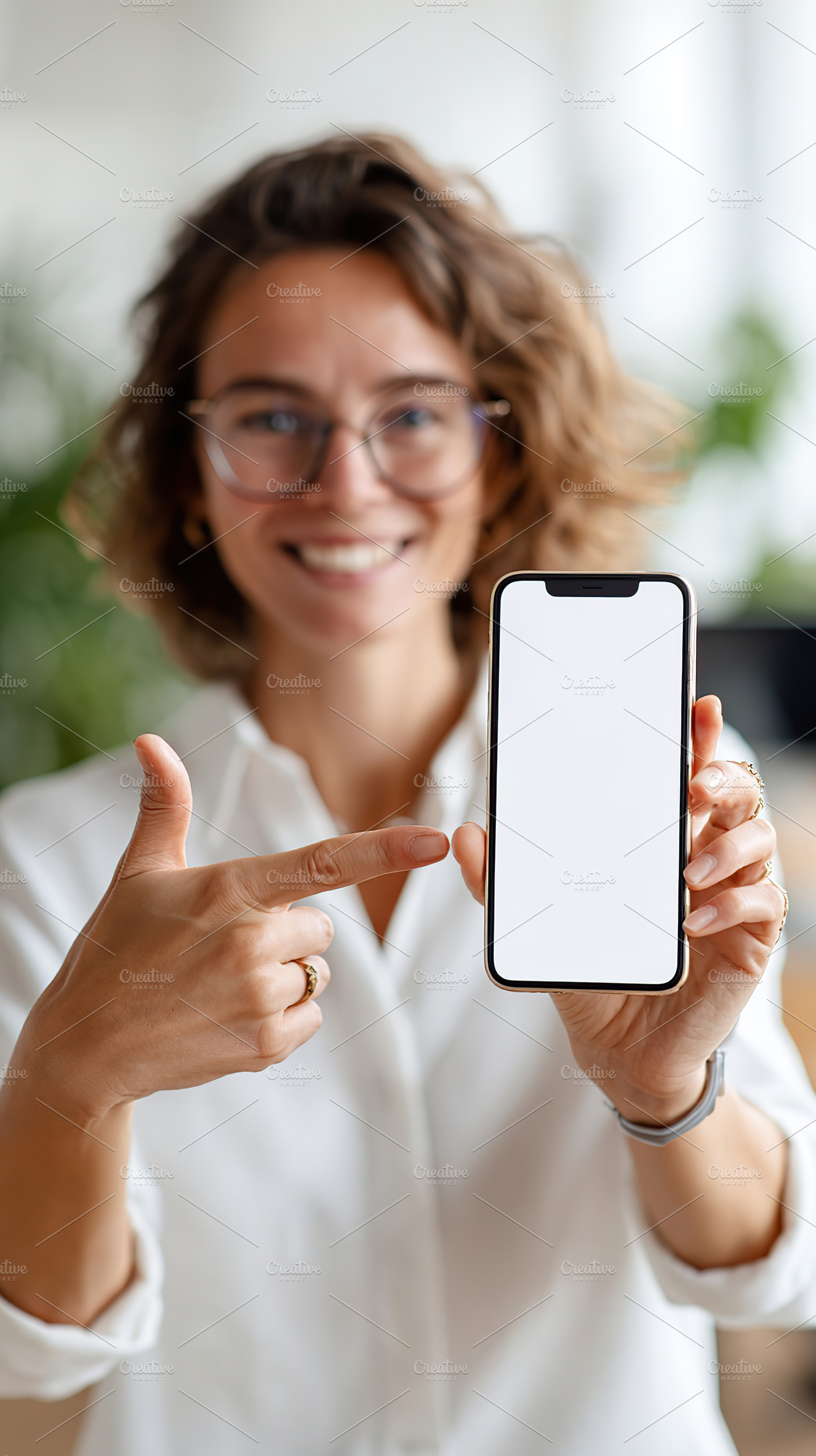 Woman points at smartphone screen in a bright office setting during daytime, a Person Photo by AlyaAnd