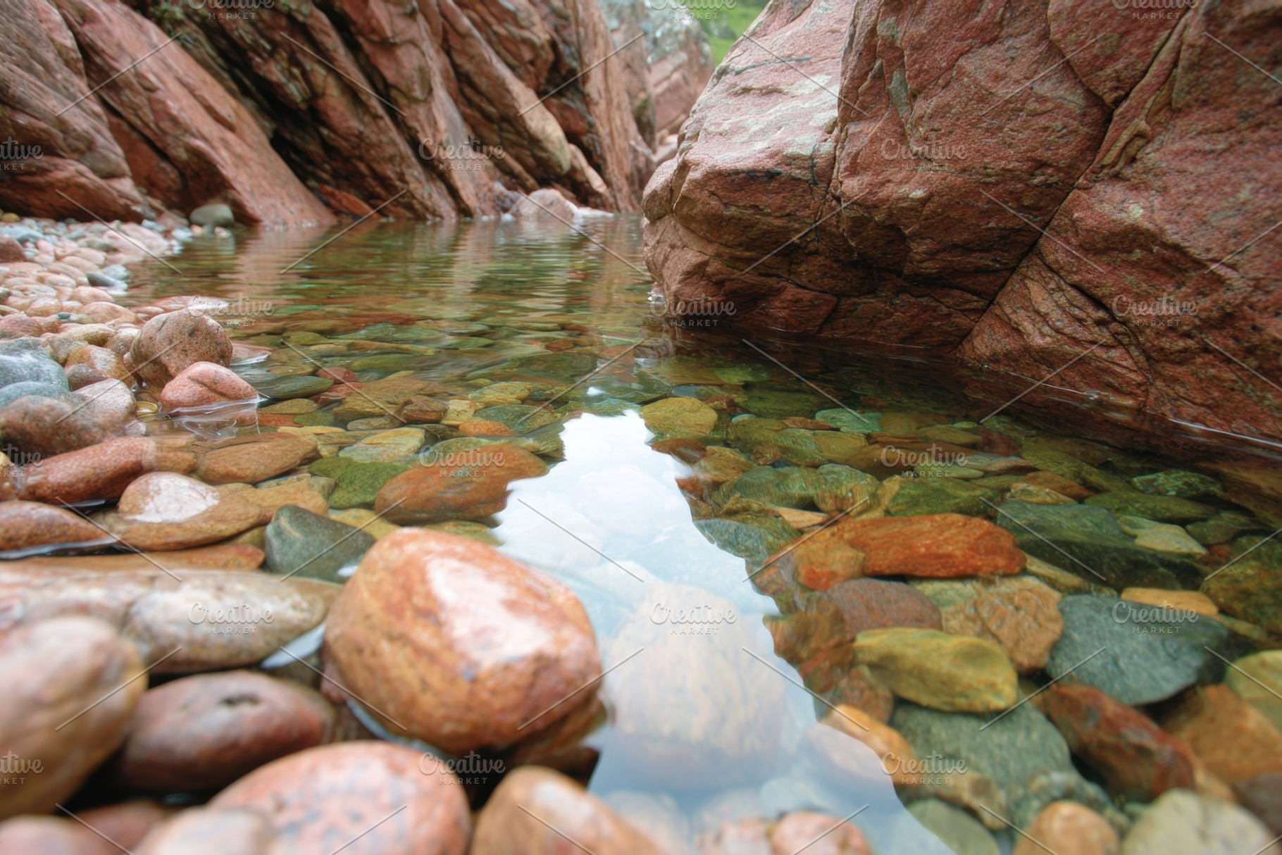 Clear Stream with Colorful Pebbles and Red Rocks, a Nature Photo by AlyaAnd