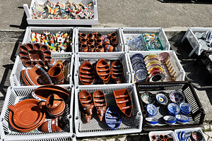 Handcrafted pottery and souvenirs displayed at a market in Nazare, Portugal, a Photo by AS photostudio