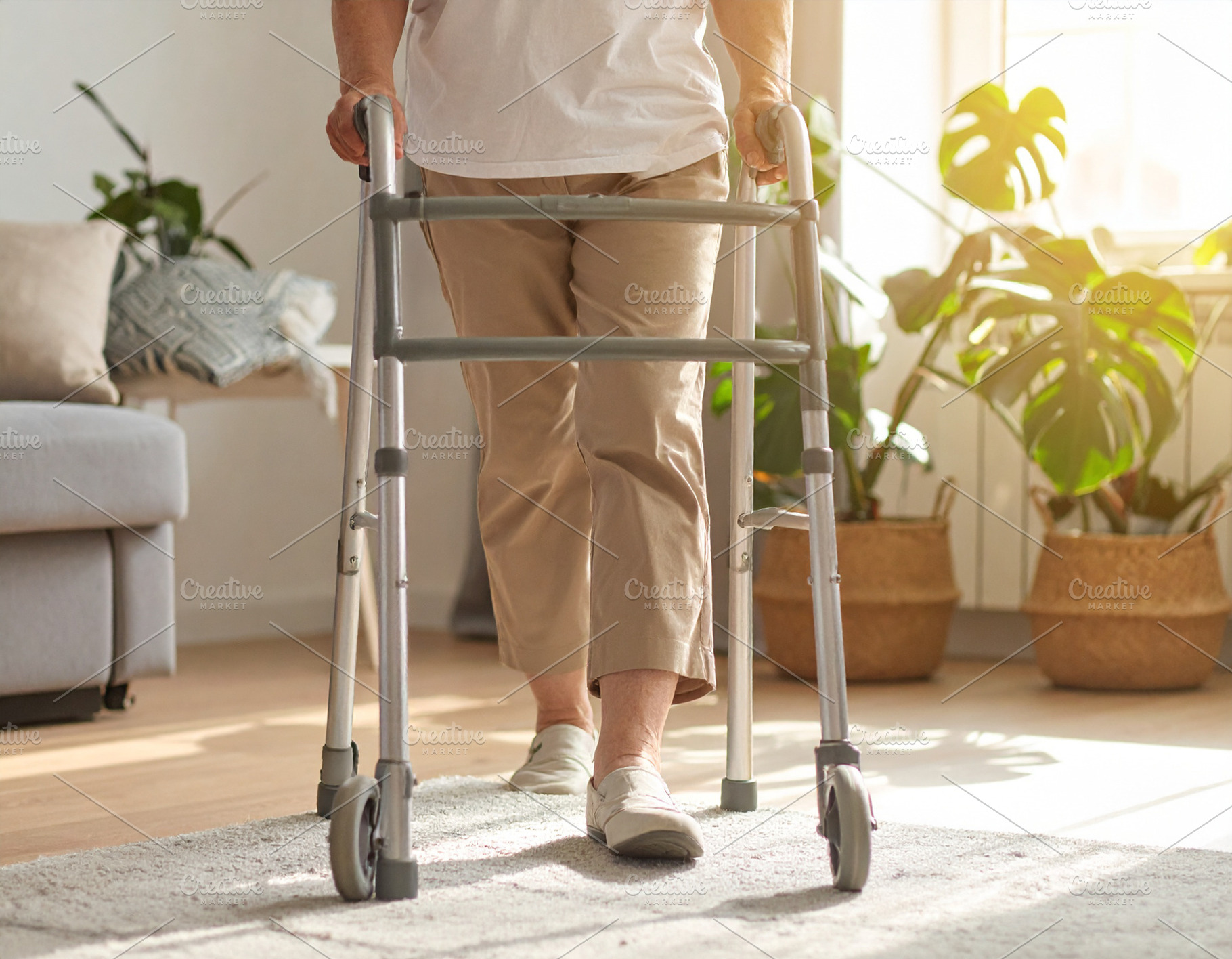 User walking with a modern walker in a living room with warm lig, a Person Photo by DanFLCreativo