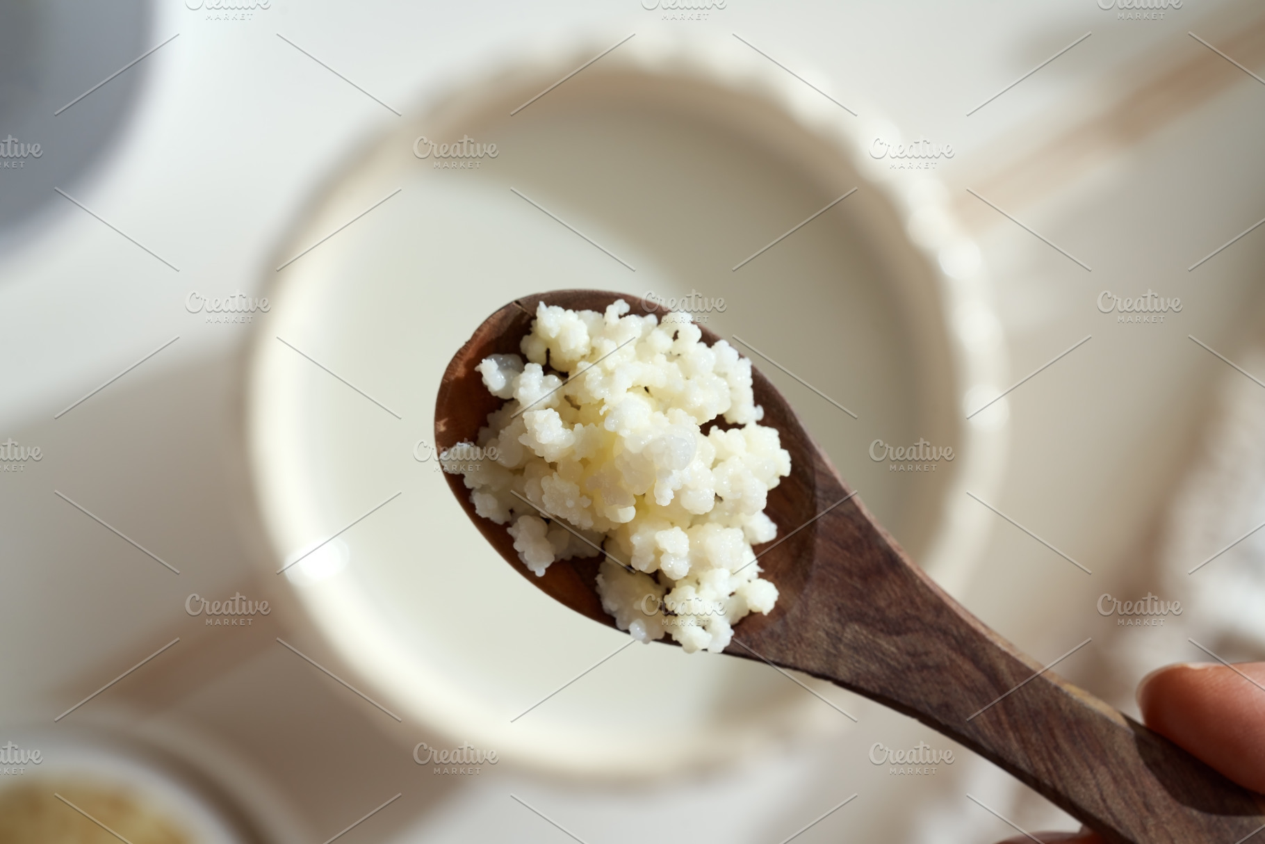 Kefir grains on a wooden spoon, top view, a Photo by Madeleine Steinbach