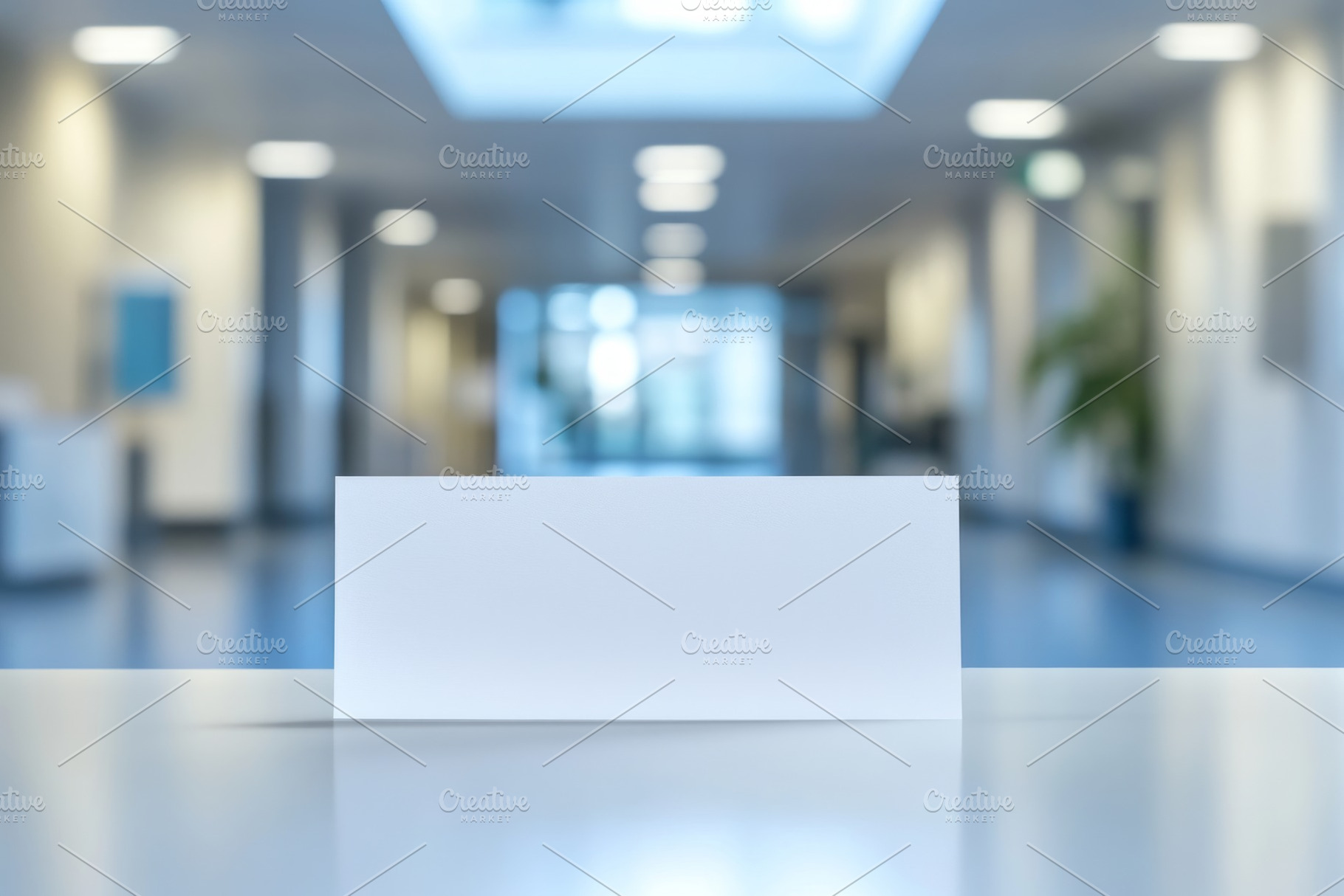 A blank white card sits on a table against a softly blurred office background,, a Background Photo by ImageMir