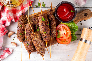 Shish kebab on stick, made from ground beef meat, a Food & Drink Photo by Rimma