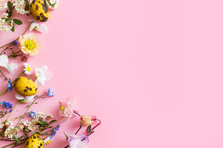 Easter flat lay. Stylish easter eggs and spring flowers on pink
