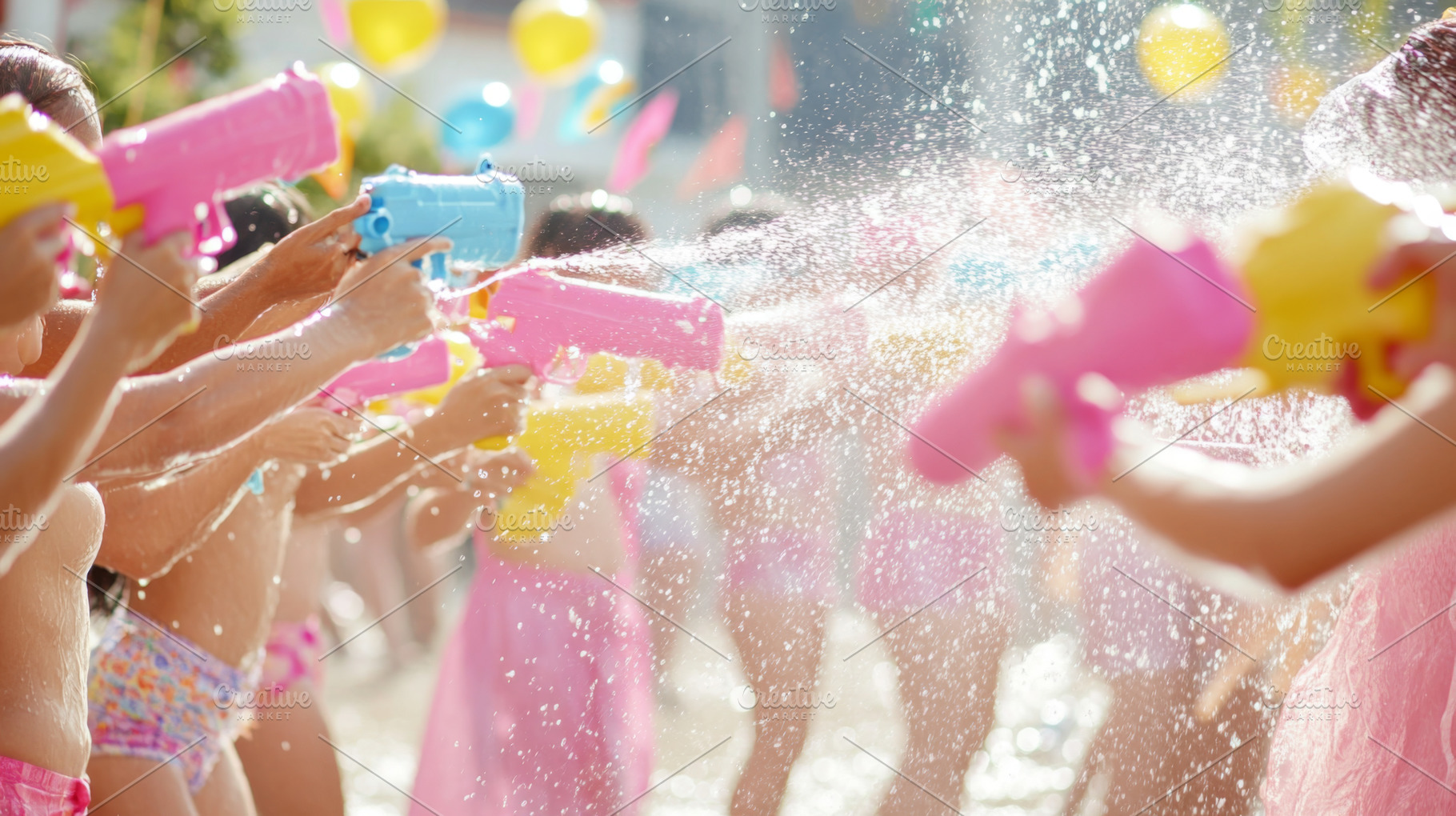 Children with Water toy spraying brightly colored stream in sunn, a Photo by Dvoevnore photos