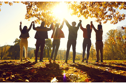 Group of friends holding hands raise, a Person Photo by StudioRomantic