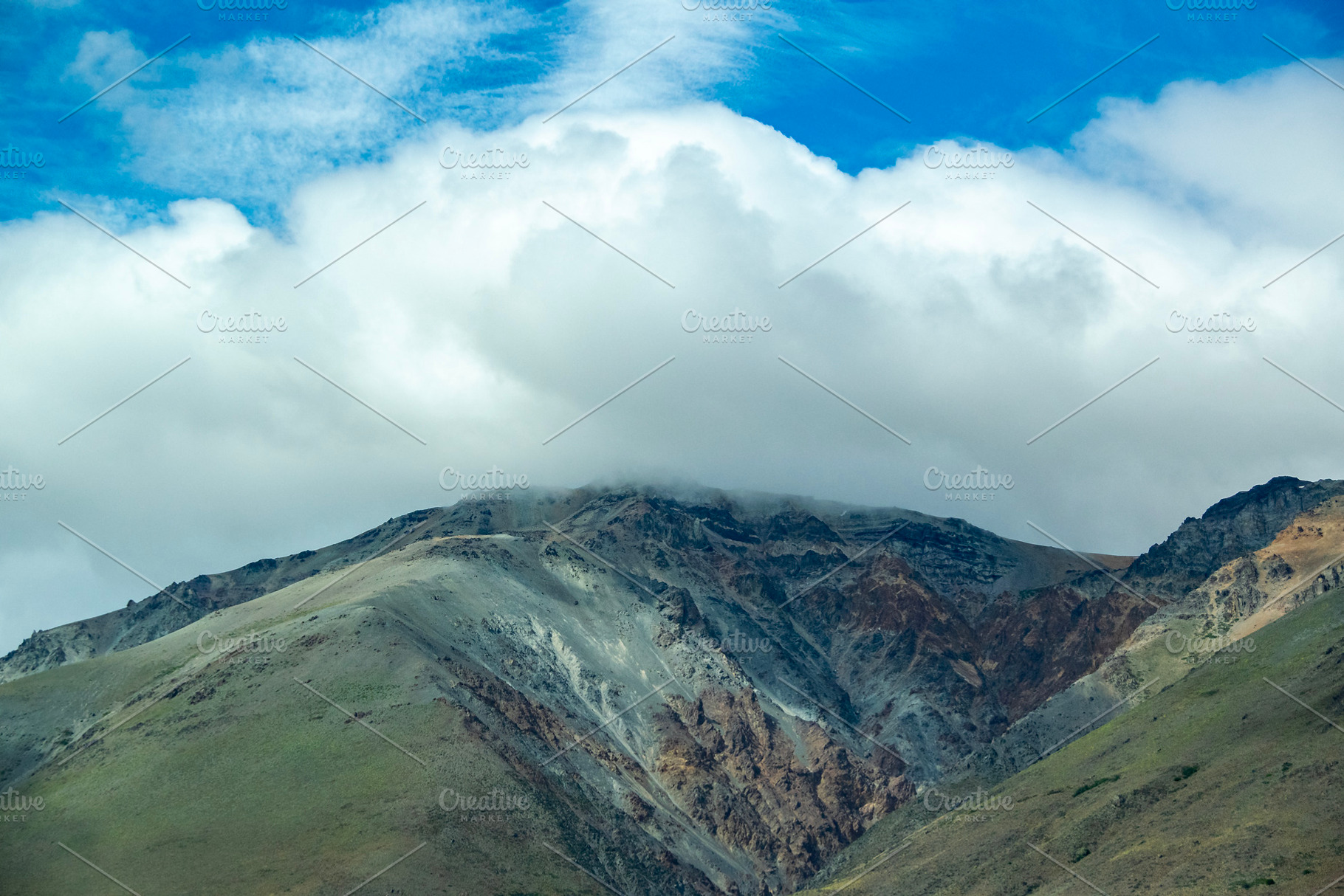 Rocky mountains covered by big clouds at top, chubut province, a, a Nature Photo by DanFLCreativo