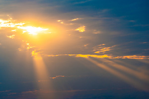 Sunset sky with sun rays through clouds, a Nature Photo by Vapi