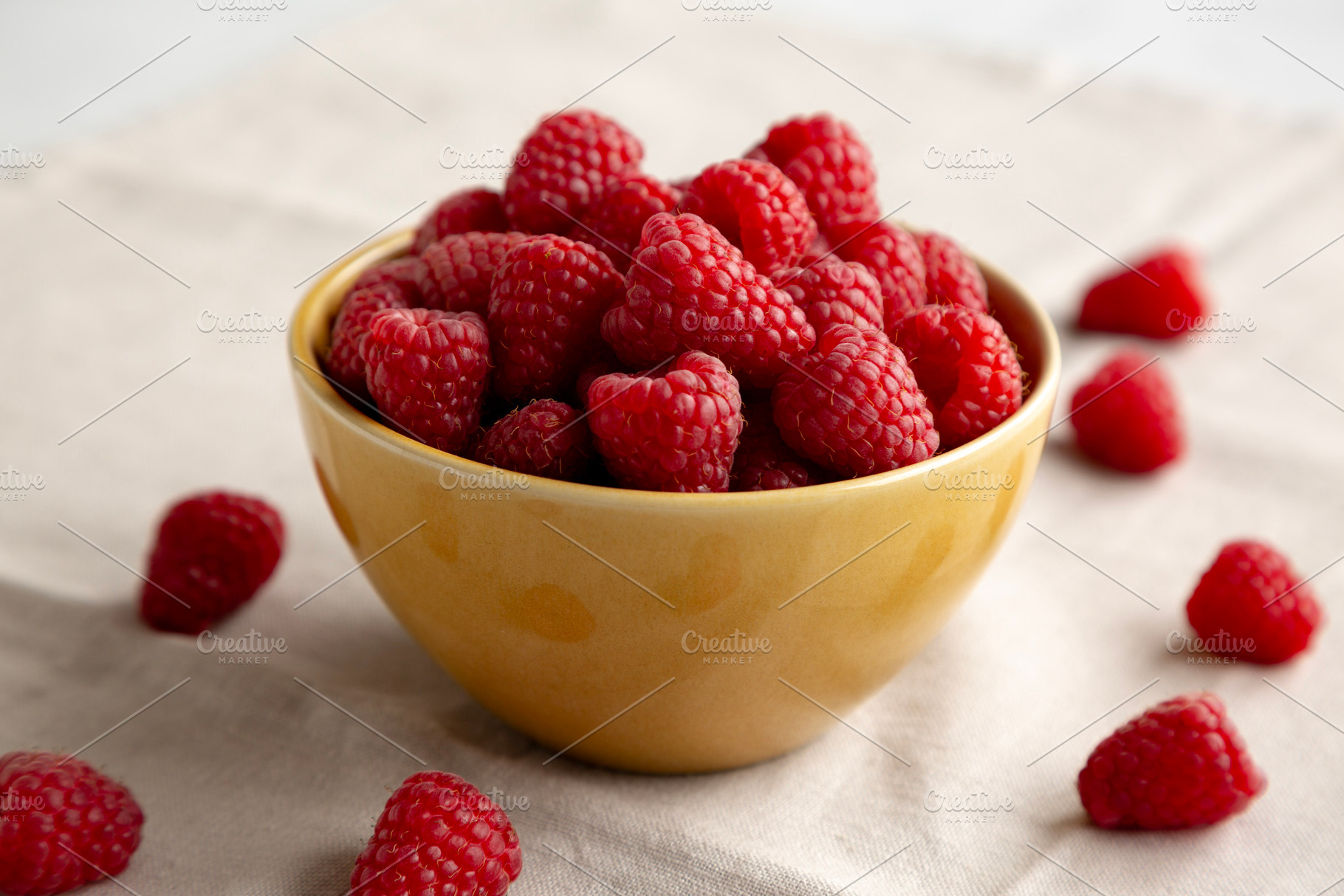 Organic Raw Red Raspberries in a Bowl, side view. Close-up., a Food & Drink Photo by LiudmylaChuhunova