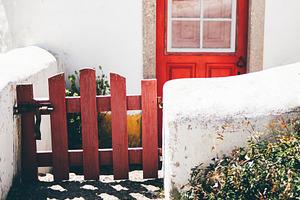 Red door and rustic white walls, an Architecture Photo by SkyNext