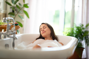 Young woman relaxing in bubble bath, a Beauty & Fashion Photo by HalfPoint