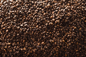 Background detail with a pile of roasted coffee beans, a Food & Drink Photo by Davizro's Market