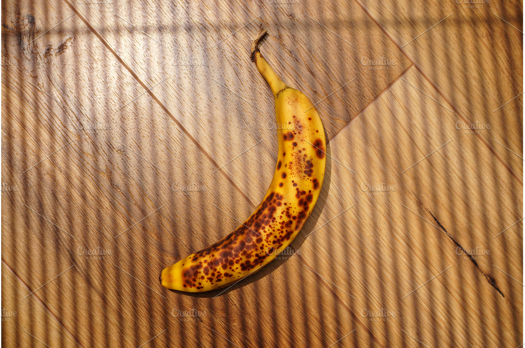Brown-spotted banana resting on, a Background Photo by darksoul72
