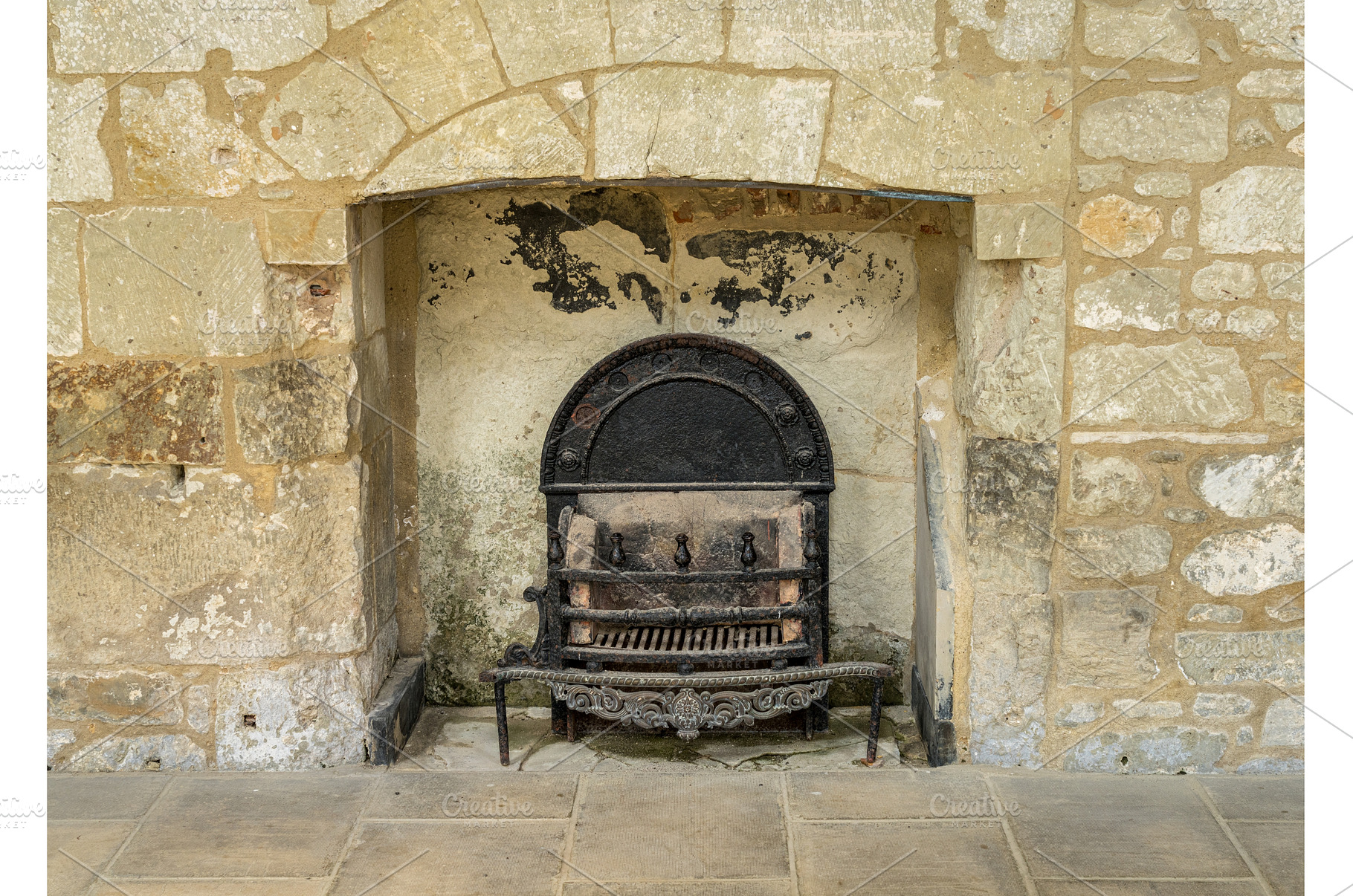 Cast iron fireplace and grate in, an Architecture Photo by Backyard Stock