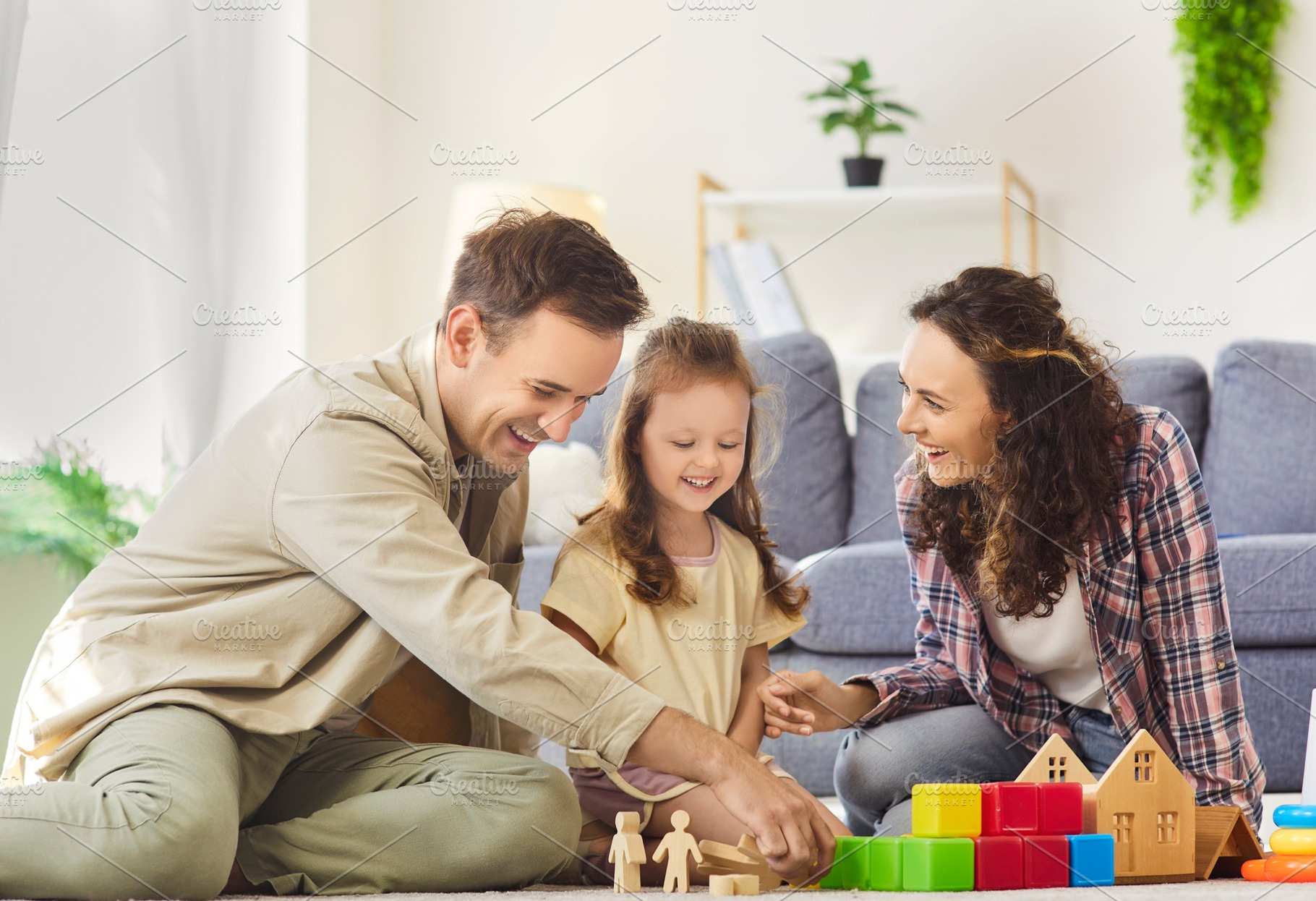 Family Building Toy Houses on Floor, a Person Photo by StudioRomantic