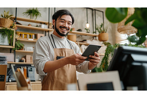 Asian male small business owner, a Person Photo by Sergey Kotenev